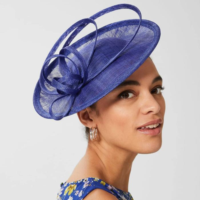 Woman in blue fascinator and blue dress