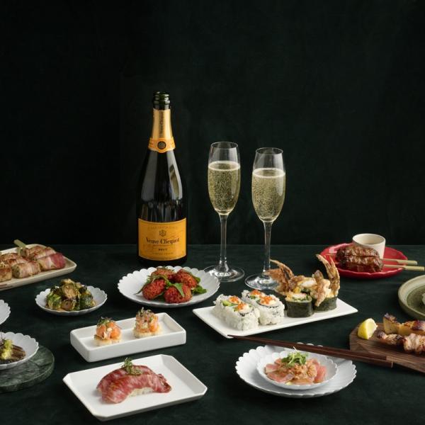 Christmas dishes from Sticks 'n' Sushi and a bottle of champagne with two glasses